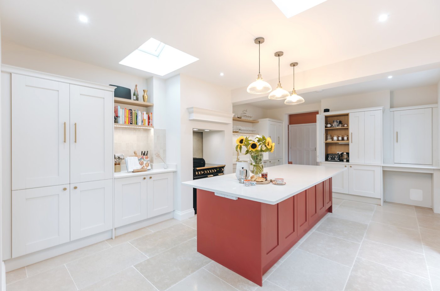 Monkmoor Road: open kitchen with rust-red island, rooflights and limestone floor