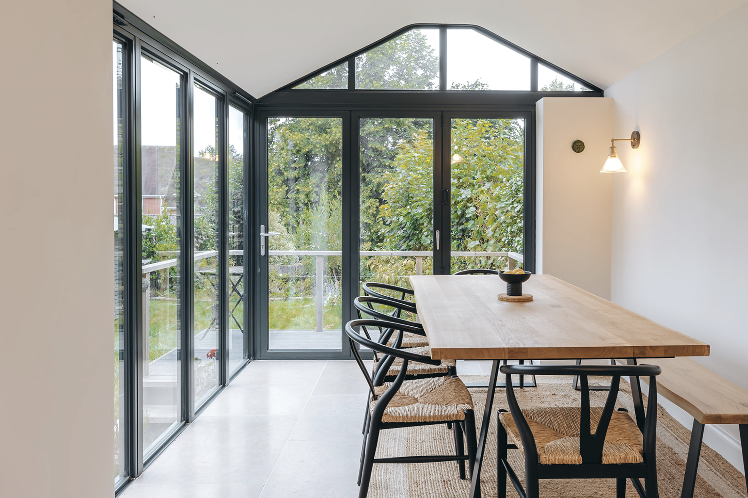 Glazed gable dining extension opening onto a garden