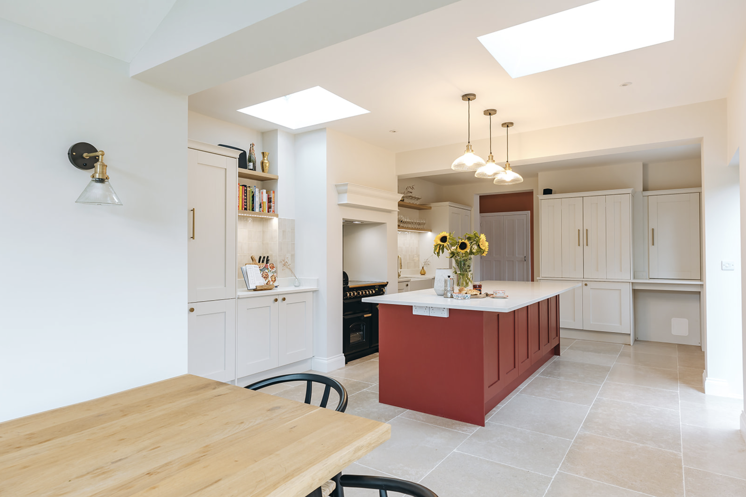 Remodelled kitchen with rust-red island in a substantial period home