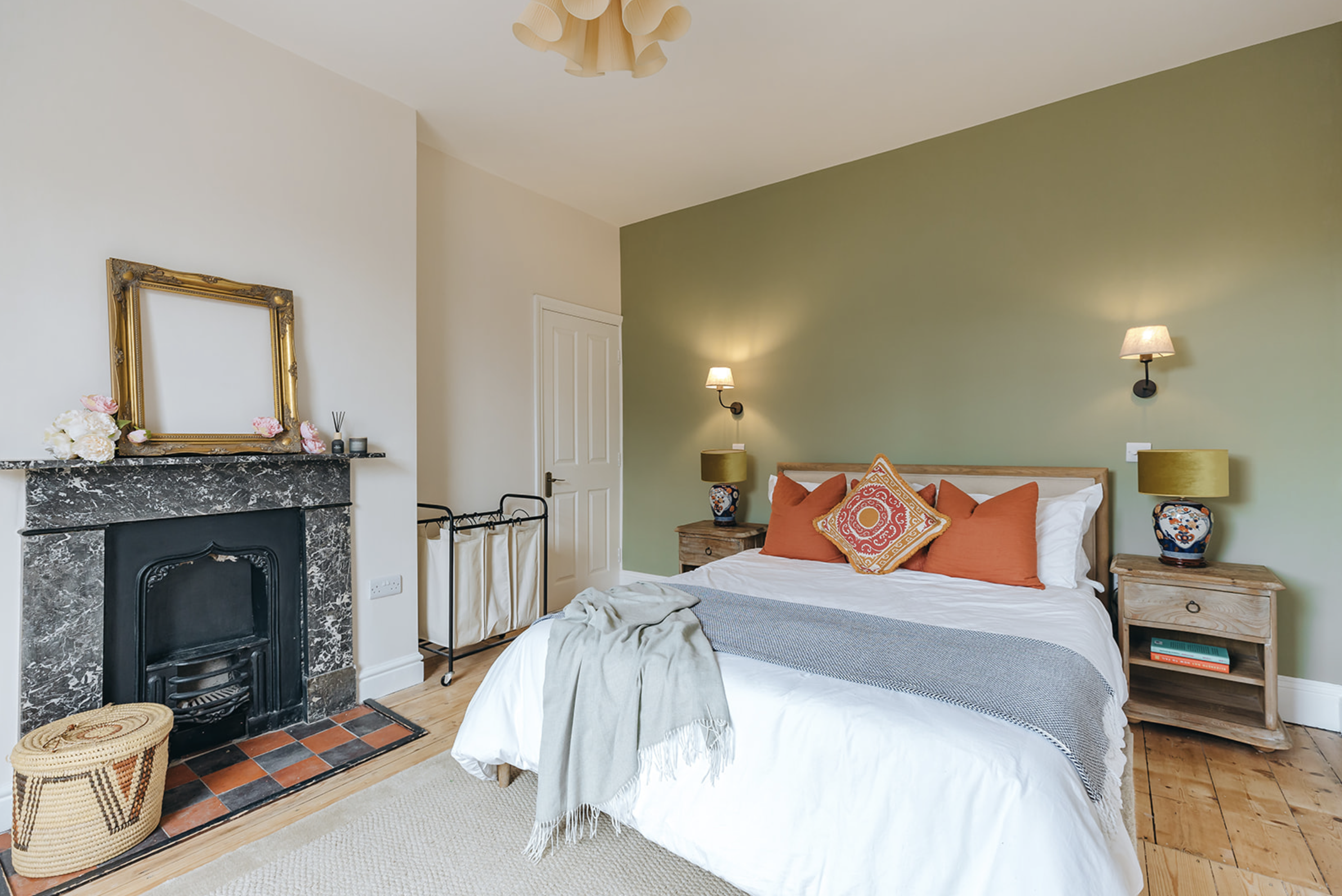 Olive bedroom with retained period fireplace