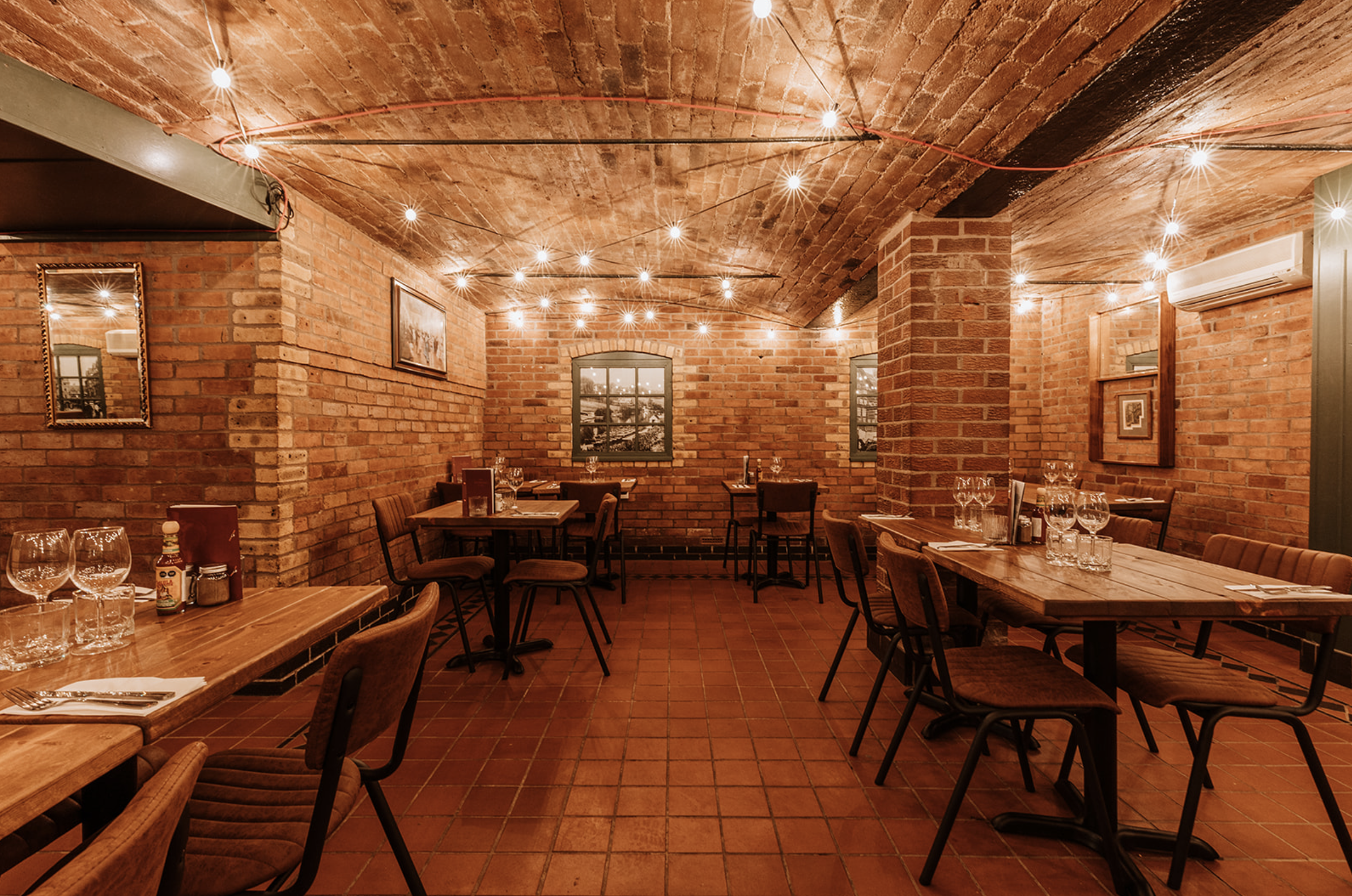 Second vaulted dining room with mirrors, framed pictures and heritage photograph windows
