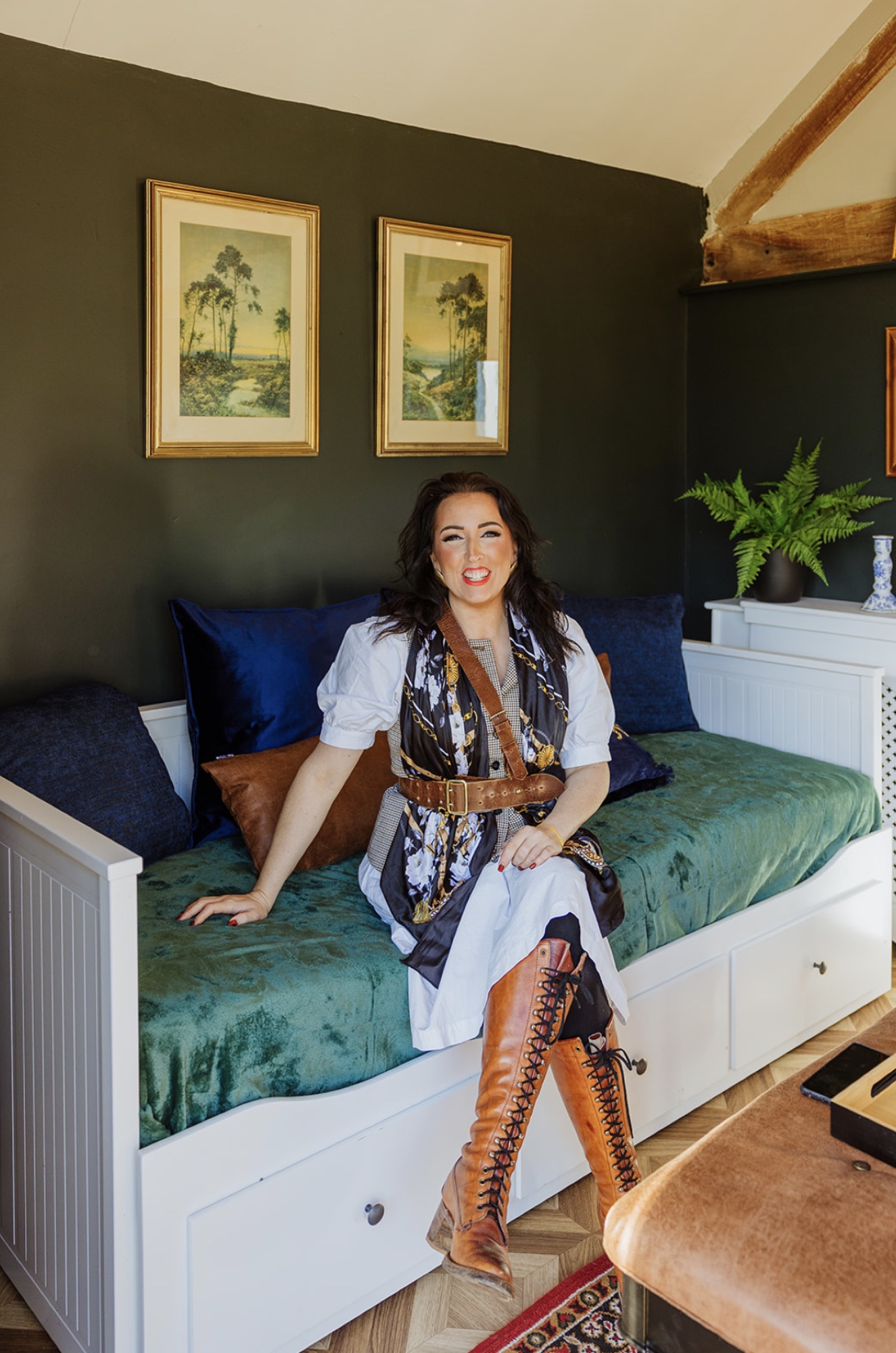Camilla seated in Fairholm's dark green snug after completion