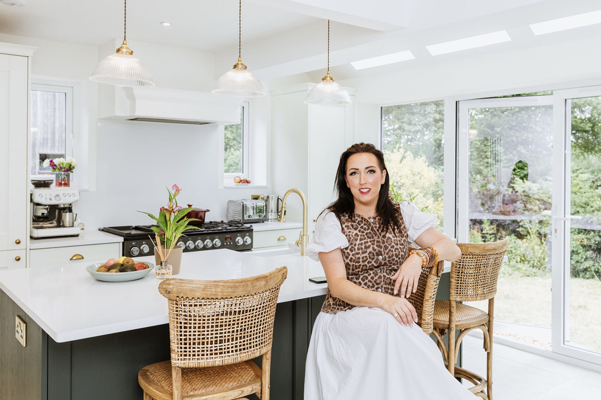 Camilla seated at the completed Fairholm kitchen island