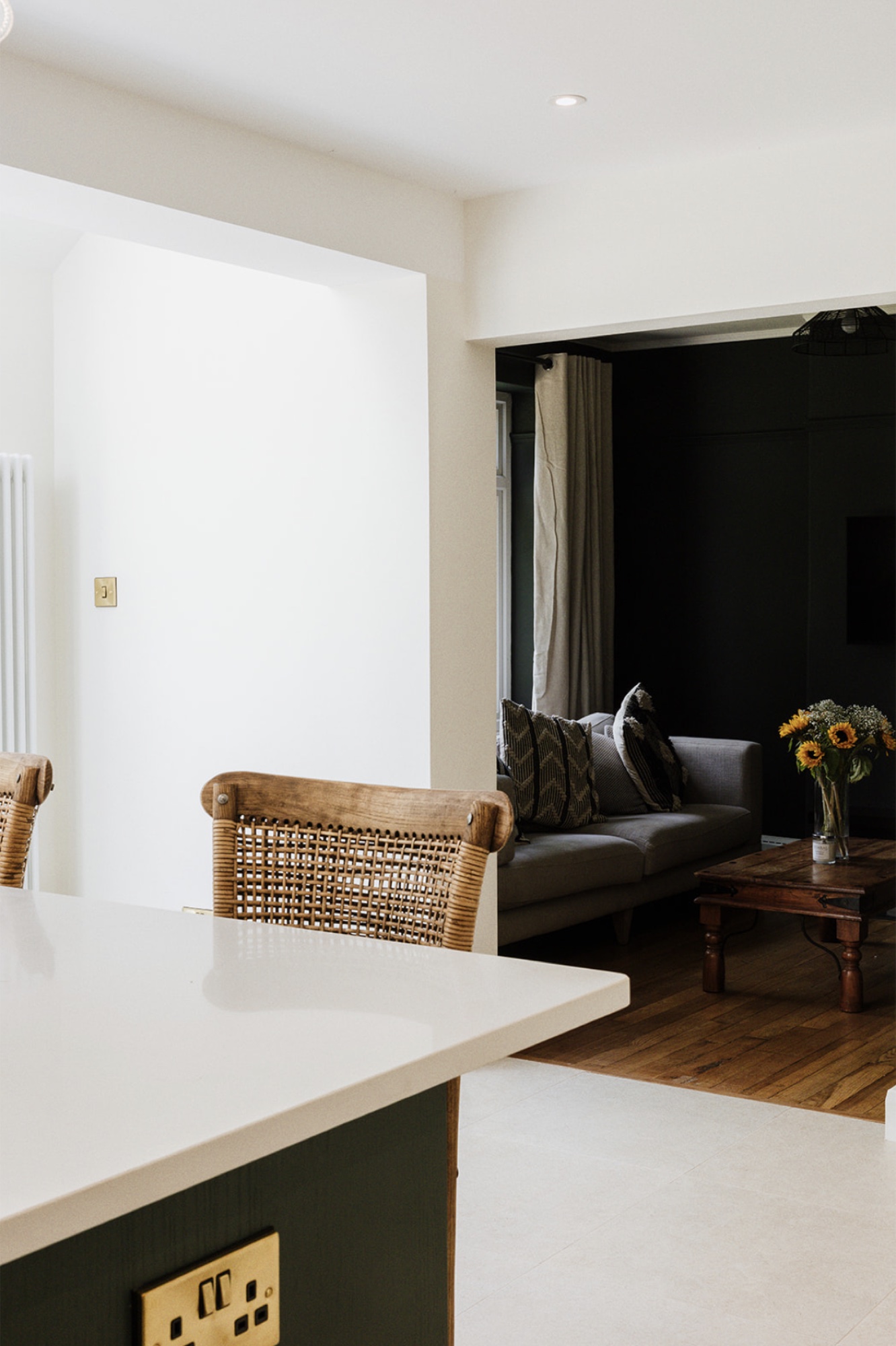 View from the kitchen island into Fairholm's dark green living room