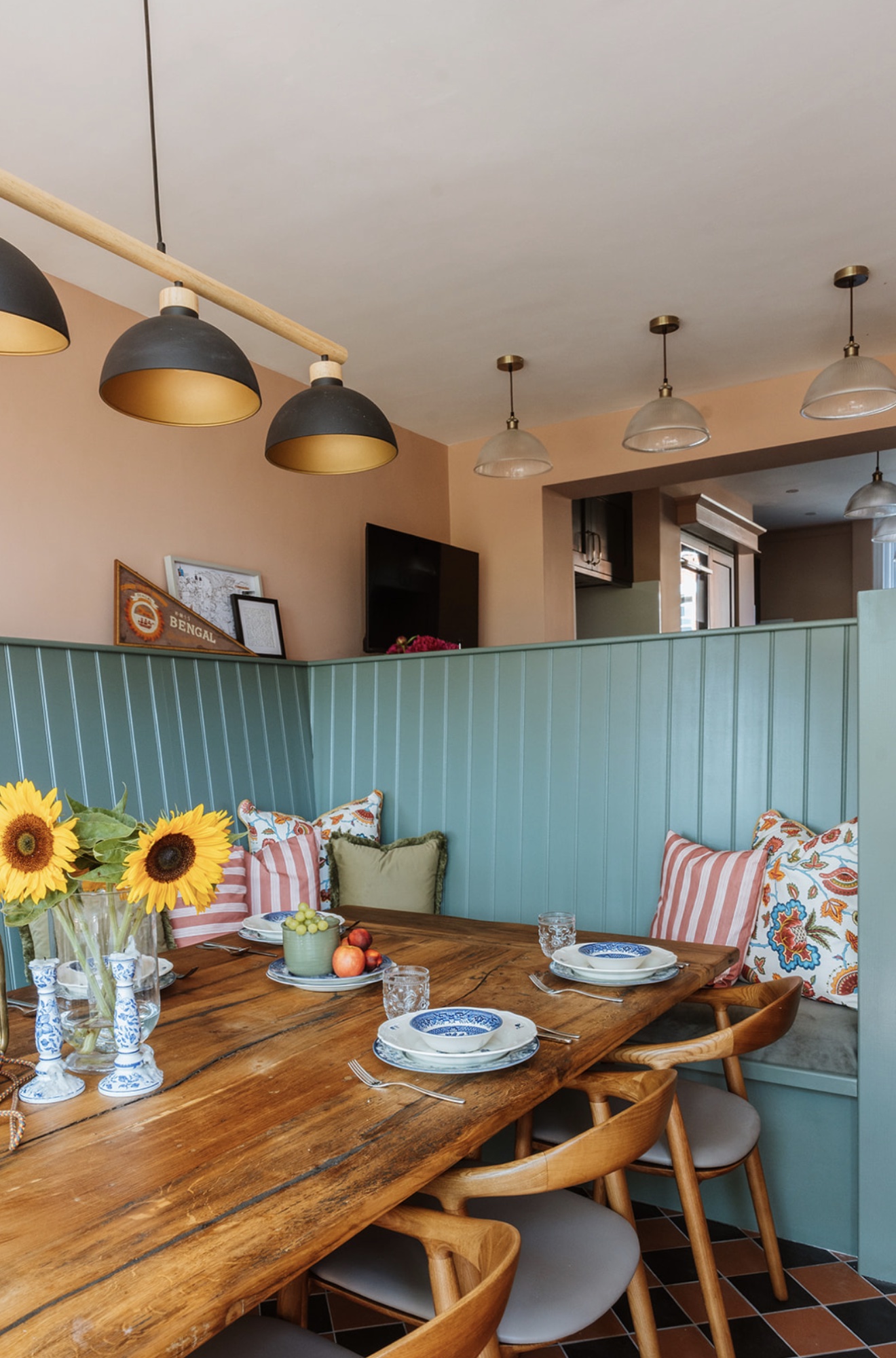 Oak Street dining area with green banquette seating and feature lighting