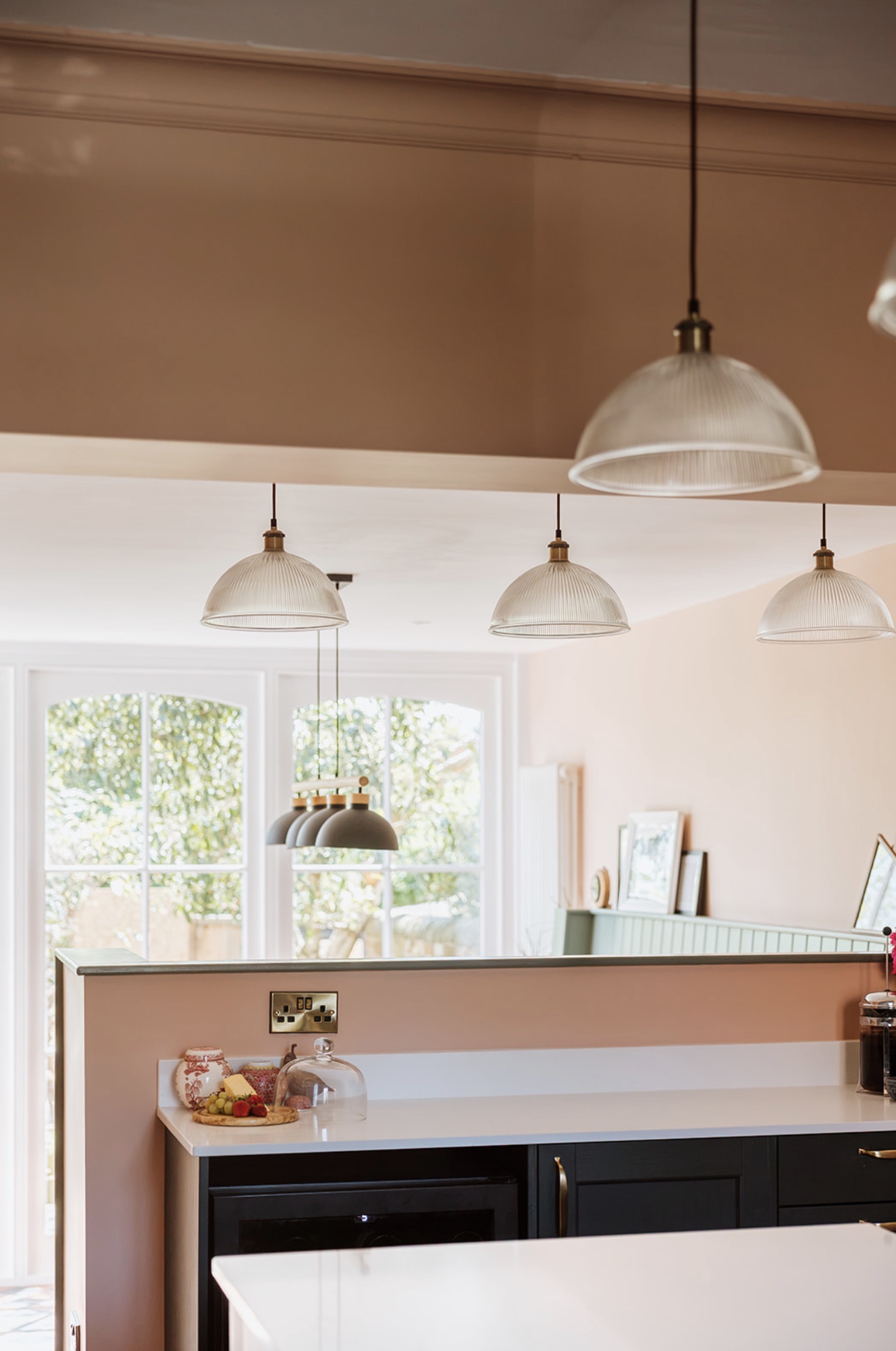 Layered pendant lighting connecting the kitchen and dining room