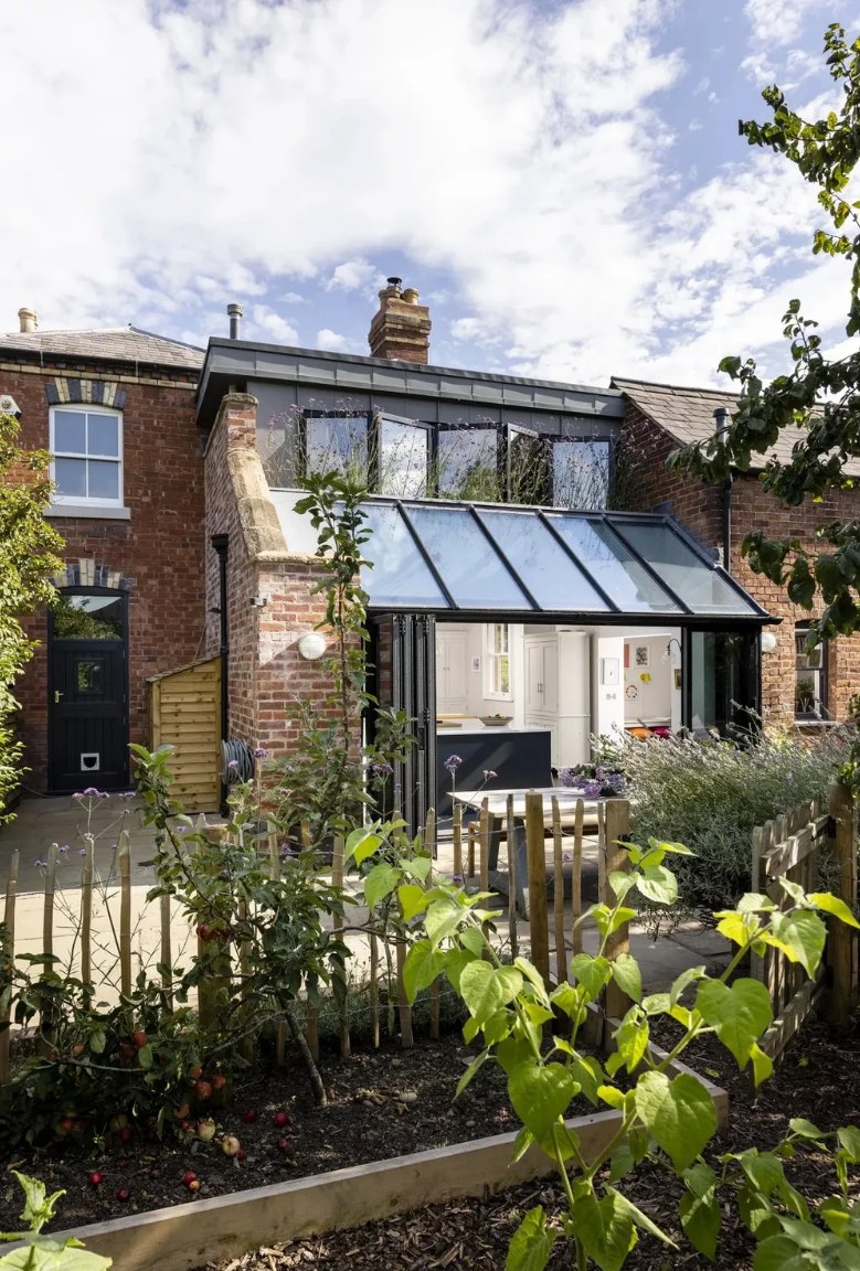 Oakleigh House: glazed extension open to the garden with the first-floor glazed link above