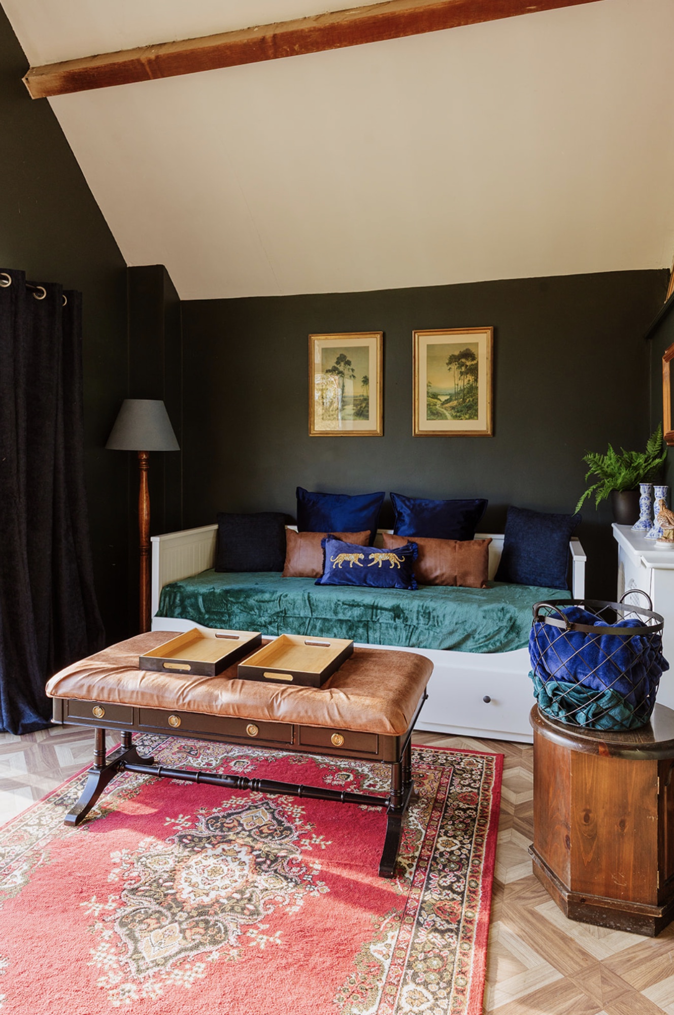 Pool House daybed with green velvet cover, patterned rug and antique upholstered bench