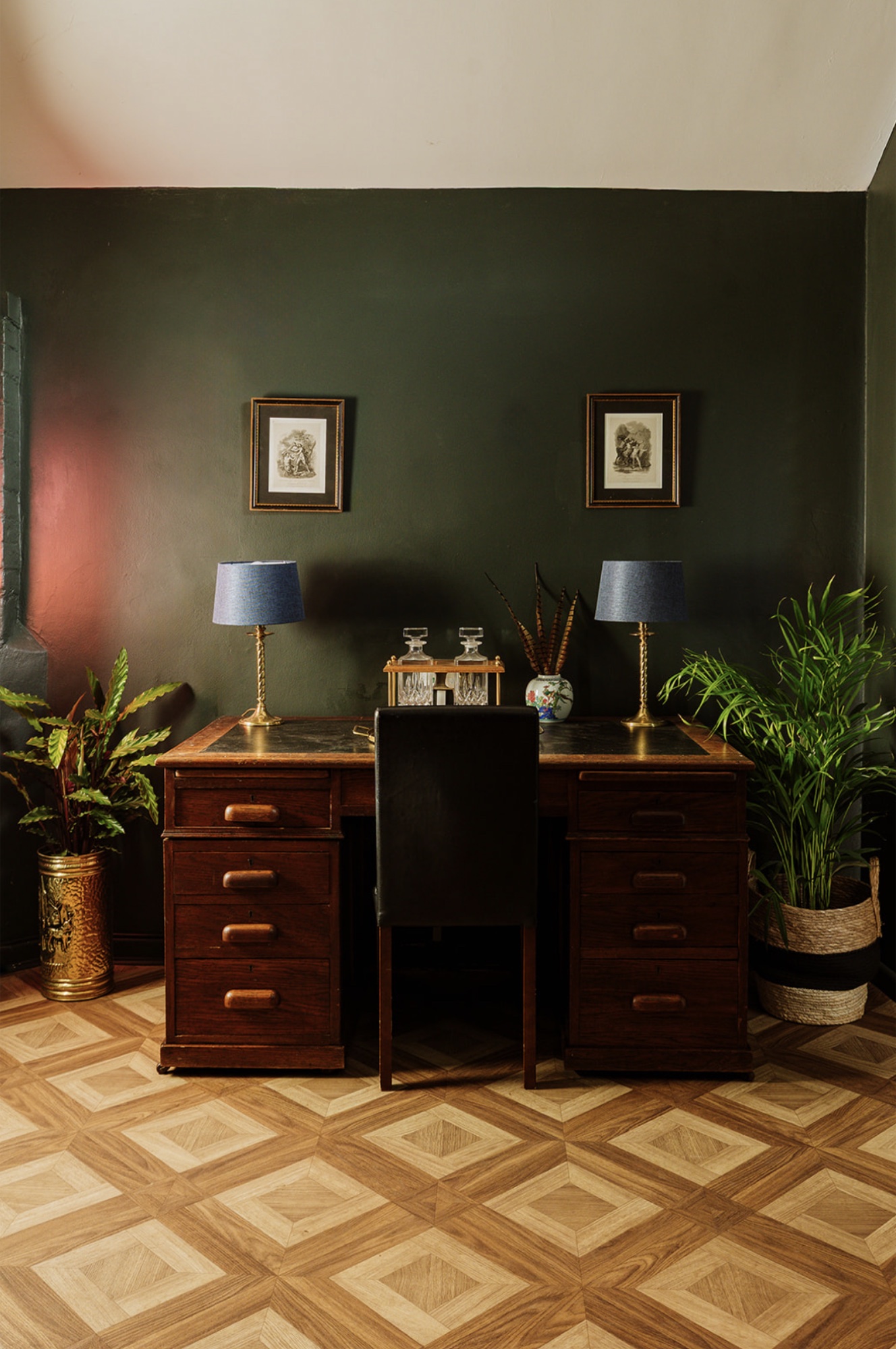 Front view of the Pool House writing desk with brass lamps and planting